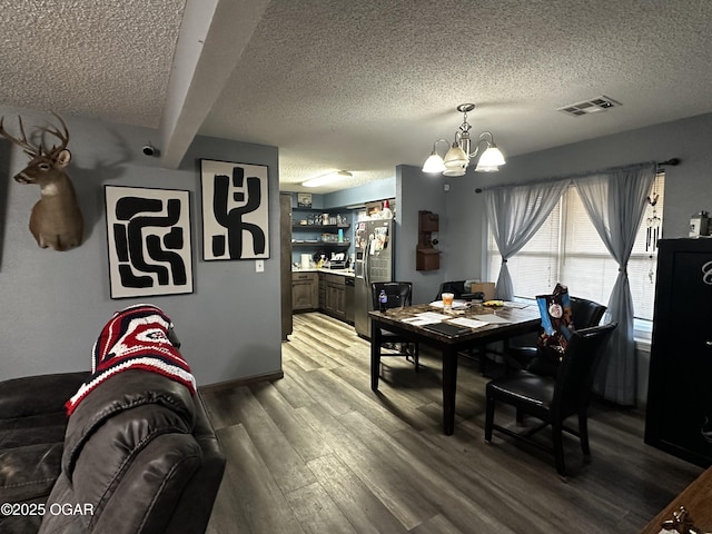 2027 P St SW, Miami, OK 74354 - dining area with light wood-style flooring, a textured ceiling, a notable chandelier, and visible vents
