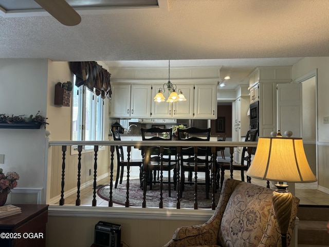 dining area with a textured ceiling, recessed lighting, light tile patterned flooring, a notable chandelier, and baseboards