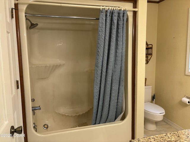 bathroom with toilet, shower / bath combo, and tile patterned flooring