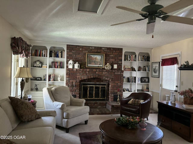 living area with a fireplace, carpet flooring, a textured ceiling, and a ceiling fan