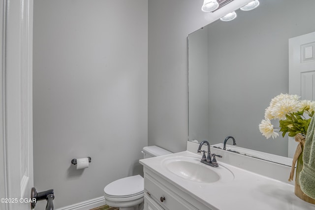 half bathroom featuring toilet and vanity
