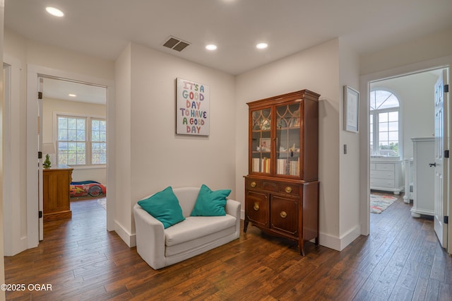 sitting room with visible vents, recessed lighting, dark wood-style floors, and baseboards