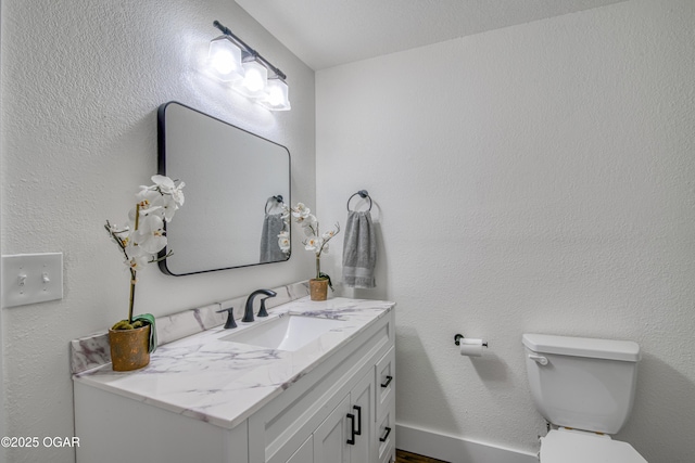 half bathroom featuring toilet and vanity