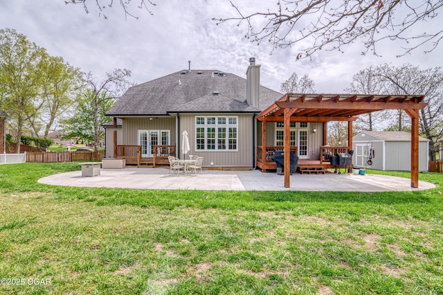 rear view of property featuring a pergola, a deck, french doors, and a patio area