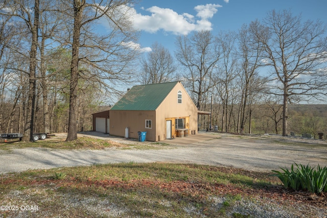 17881 Goldfinch Rd, Neosho, MO 64850 - view of property exterior with a garage, driveway, and metal roof