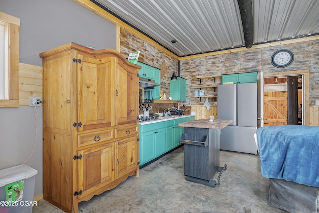 17881 Goldfinch Rd, Neosho, MO 64850 - kitchen with freestanding refrigerator, concrete flooring, pendant lighting, under cabinet range hood, and wooden counters