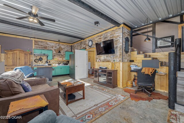 17881 Goldfinch Rd, Neosho, MO 64850 - living room featuring concrete floors, a ceiling fan, and wood walls
