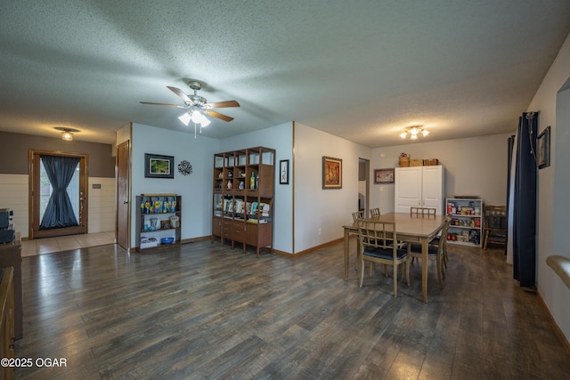 dining area with ceiling fan, baseboards, wood finished floors, and a textured ceiling