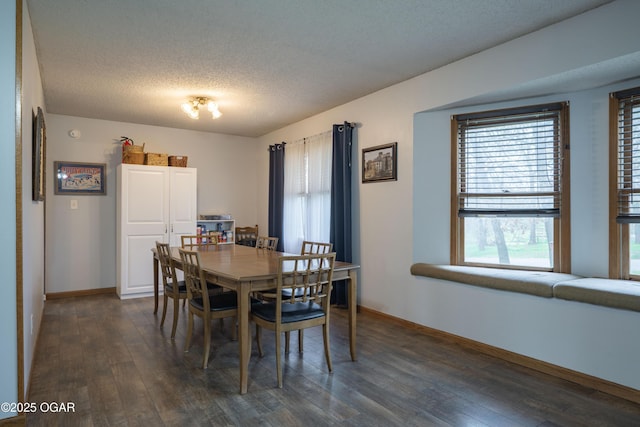 dining space featuring baseboards, dark wood-type flooring, and a textured ceiling