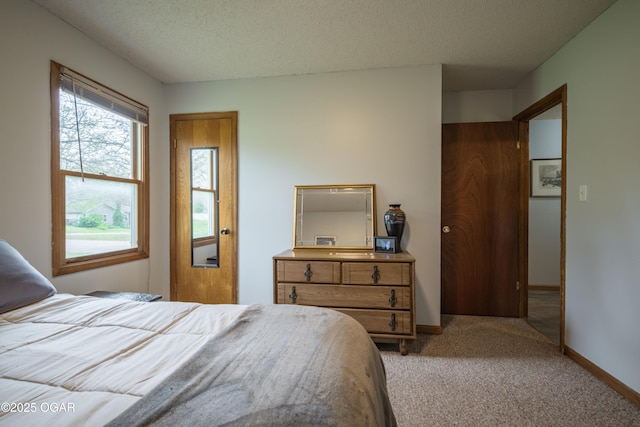 carpeted bedroom with baseboards and a textured ceiling