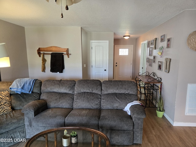 2798 Neosho Heights Ave, Neosho, MO 64850 - living area featuring baseboards, wood finished floors, visible vents, and a textured ceiling