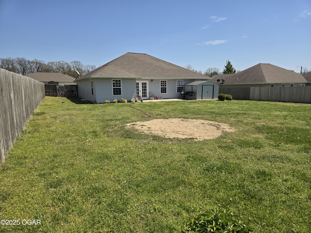 2798 Neosho Heights Ave, Neosho, MO 64850 - back of property with a fenced backyard, an outdoor structure, a storage shed, and a yard
