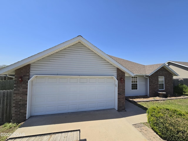 2798 Neosho Heights Ave, Neosho, MO 64850 - single story home featuring brick siding, an attached garage, driveway, and fence