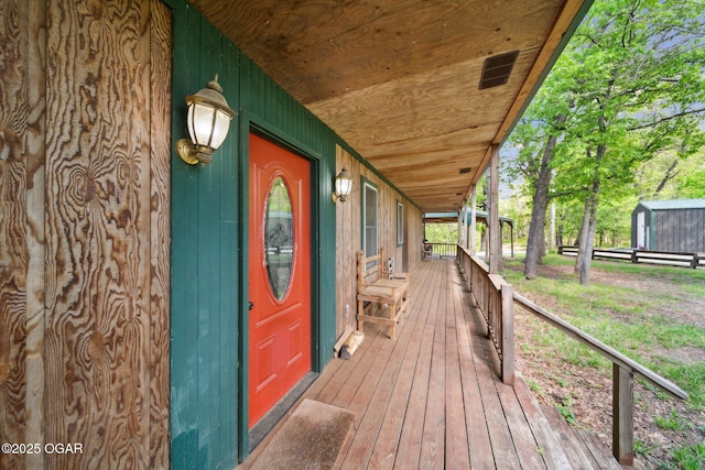 24336 S Hilltop Dr, Afton, OK 74331 - wooden deck with a shed and an outbuilding