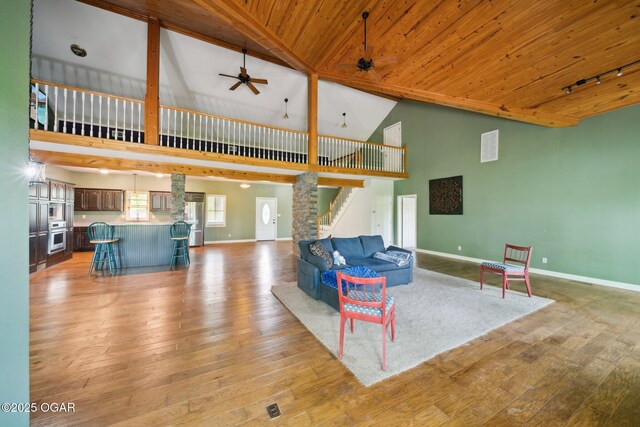 24336 S Hilltop Dr, Afton, OK 74331 - living area featuring baseboards, light wood-style flooring, high vaulted ceiling, and wooden ceiling