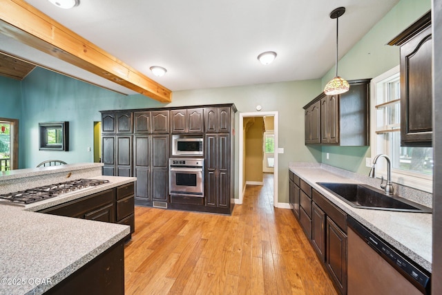 24336 S Hilltop Dr, Afton, OK 74331 - kitchen with a sink, appliances with stainless steel finishes, dark brown cabinetry, and light countertops