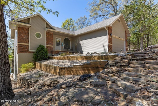 21425 Black Oak Dr, Garfield, AR 72732 - view of front of home featuring brick siding, an attached garage, and roof with shingles
