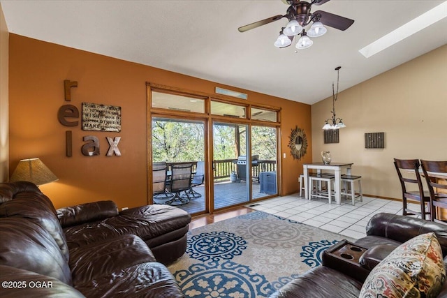 21425 Black Oak Dr, Garfield, AR 72732 - living area with lofted ceiling, ceiling fan, tile patterned floors, a skylight, and baseboards