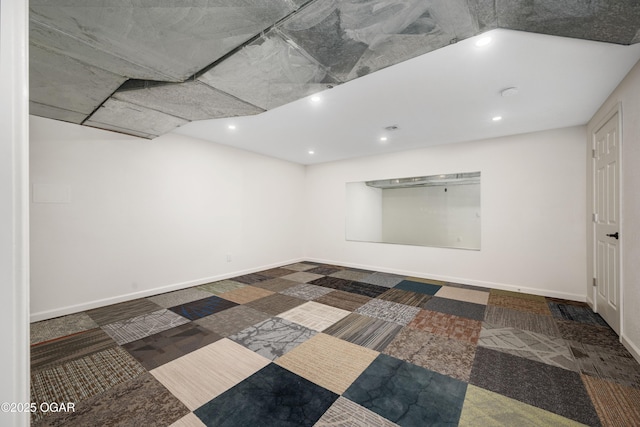 empty room featuring baseboards and recessed lighting