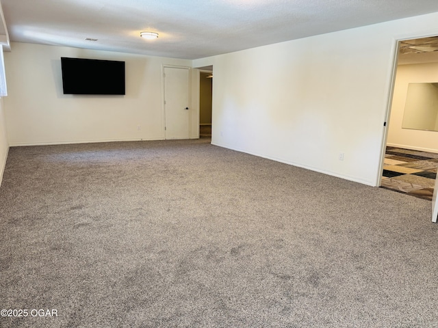carpeted spare room featuring baseboards