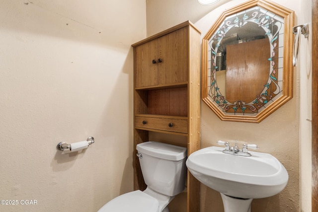 bathroom with toilet and a sink