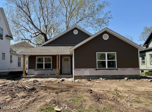 view of front of home featuring a porch and a shingled roof