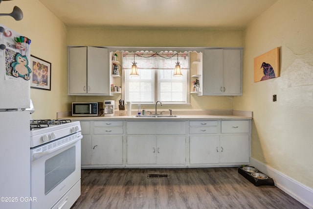 kitchen with open shelves, a sink, white appliances, and light countertops