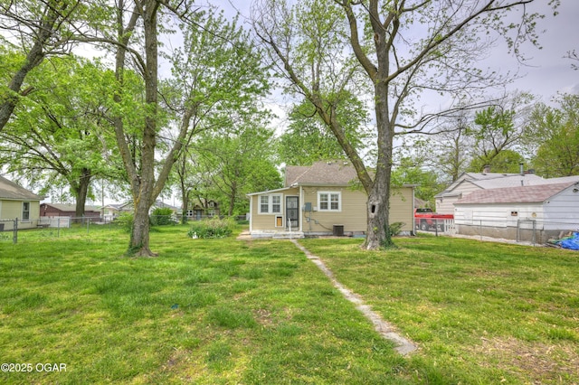 view of yard featuring central AC and fence private yard