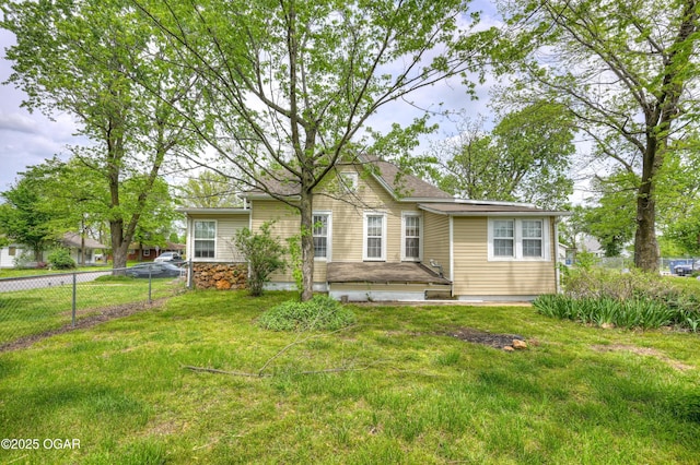 ranch-style home featuring fence and a front yard