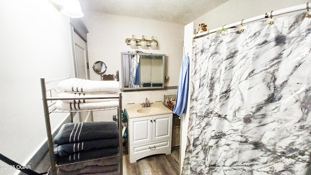 429 N Wall Ave, Joplin, MO 64801 - bathroom with curtained shower, vanity, a textured ceiling, and wood finished floors