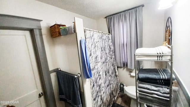 429 N Wall Ave, Joplin, MO 64801 - bathroom featuring toilet, a shower with curtain, and wood finished floors