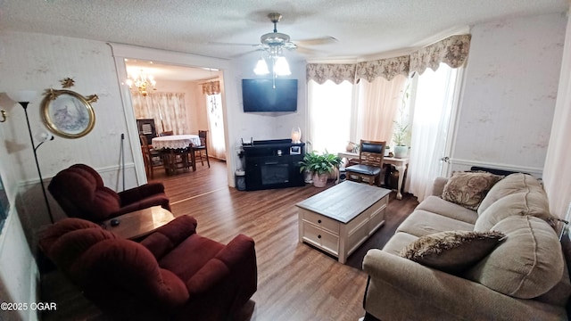 429 N Wall Ave, Joplin, MO 64801 - living area with a textured ceiling, wood finished floors, and ceiling fan with notable chandelier