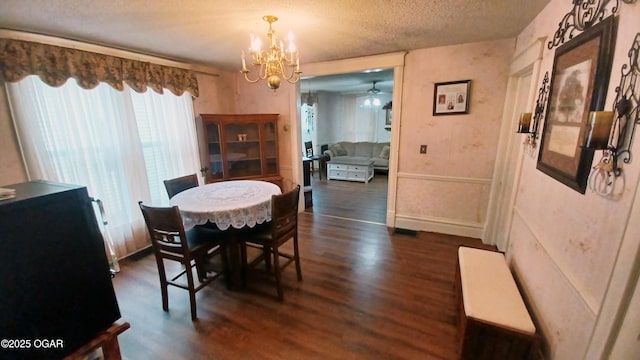429 N Wall Ave, Joplin, MO 64801 - dining space with dark wood-style floors, a textured ceiling, and ceiling fan with notable chandelier