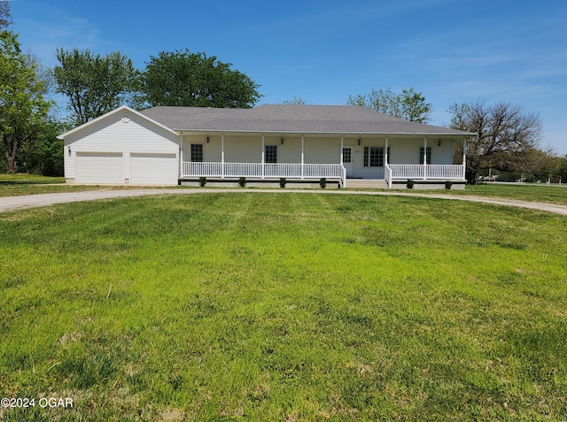 305 E Maple St, Liberal, MO 64762 - farmhouse-style home featuring driveway, covered porch, and a front yard