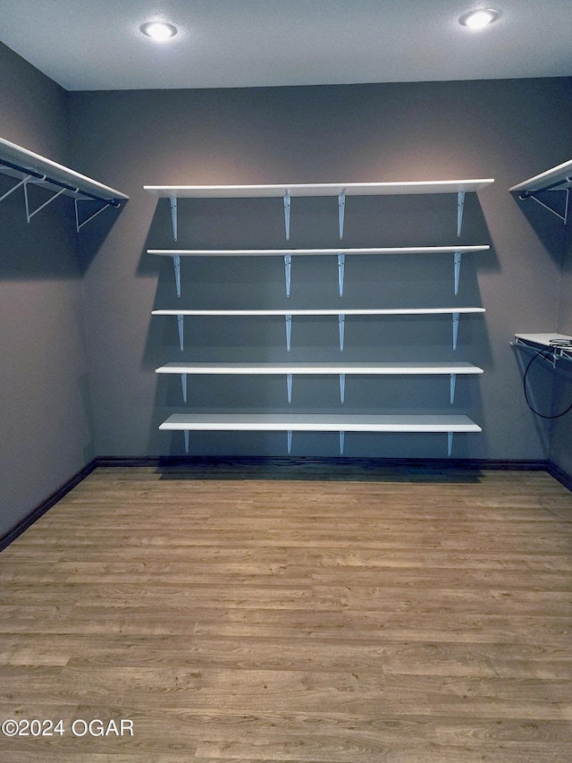 305 E Maple St, Liberal, MO 64762 - spacious closet with wood finished floors