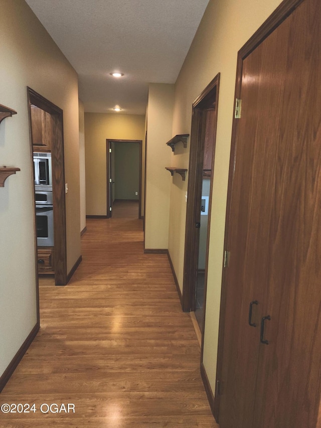 305 E Maple St, Liberal, MO 64762 - hallway with baseboards, recessed lighting, and wood finished floors