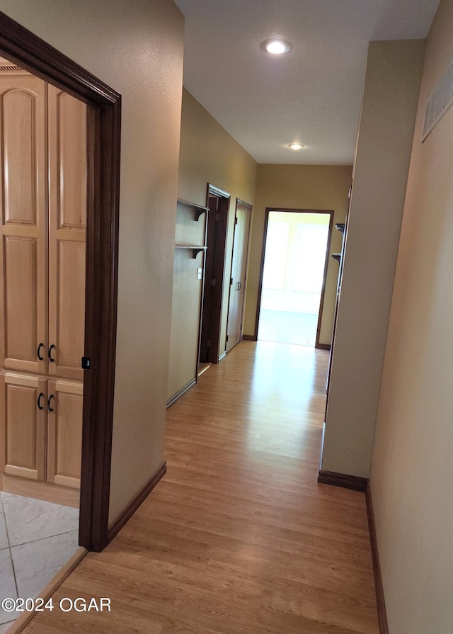 305 E Maple St, Liberal, MO 64762 - hallway featuring baseboards, recessed lighting, and light wood-style floors