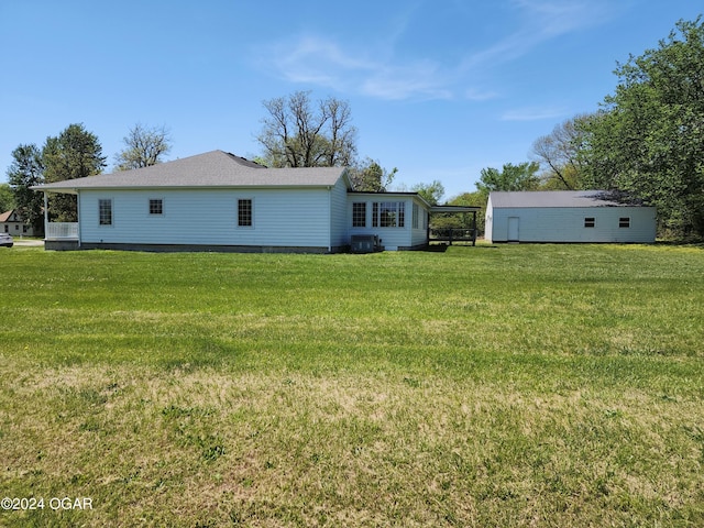 305 E Maple St, Liberal, MO 64762 - back of property with a lawn and central AC