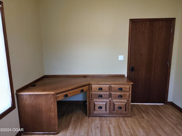 305 E Maple St, Liberal, MO 64762 - unfurnished office featuring baseboards and light wood-style flooring