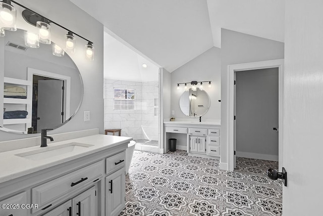 bathroom with walk in shower, vaulted ceiling, two vanities, tile patterned floors, and baseboards
