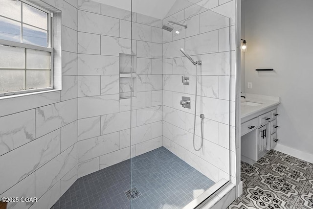 full bathroom featuring a shower stall, vanity, and baseboards