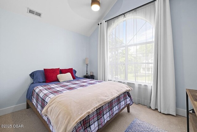 carpeted bedroom featuring vaulted ceiling, baseboards, and ceiling fan