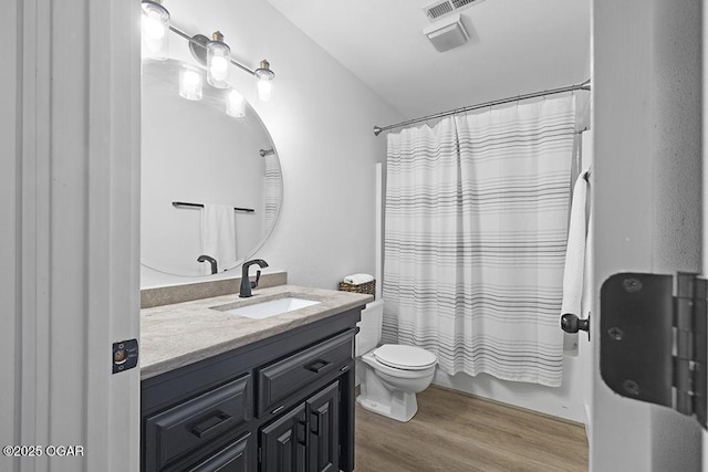 full bath with vanity, wood finished floors, toilet, and shower / bathtub combination with curtain