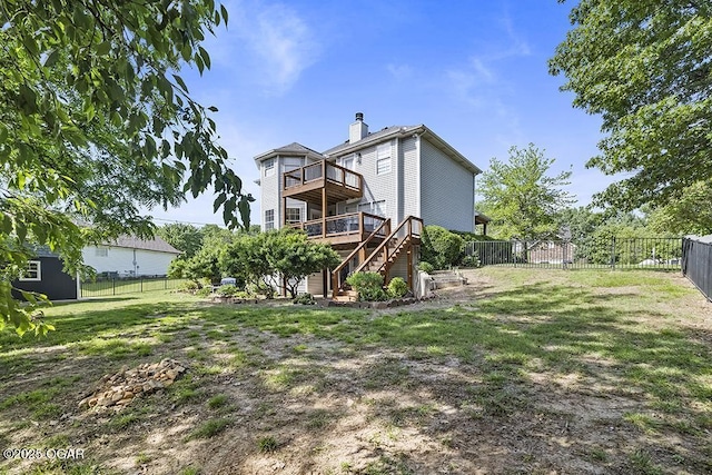 back of property featuring stairs, a wooden deck, and a chimney