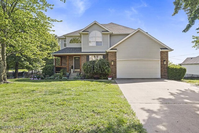 traditional-style home with brick siding, driveway, covered porch, and a garage