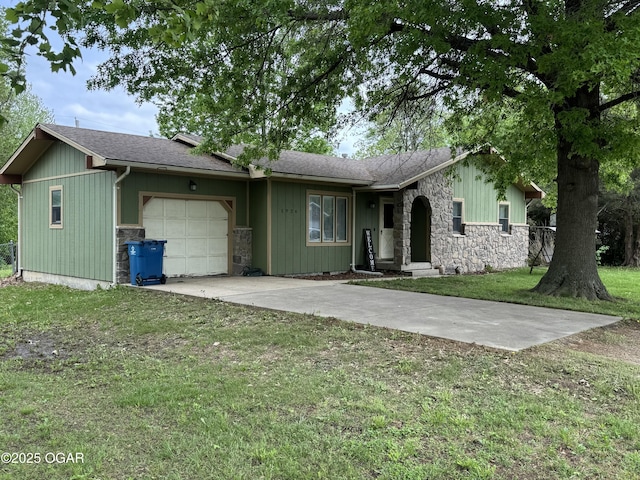 ranch-style home featuring a front lawn, driveway, stone siding, roof with shingles, and an attached garage
