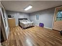 105 S Elm St, Mulberry, KS 66756 - bedroom featuring baseboards and wood finished floors
