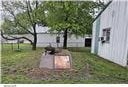 105 S Elm St, Mulberry, KS 66756 - entry to storm shelter with a lawn
