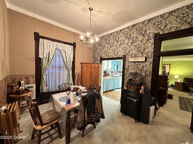 301 S 7th St, Sarcoxie, MO 64862 - dining space featuring a wainscoted wall, ornamental molding, carpet, and a notable chandelier