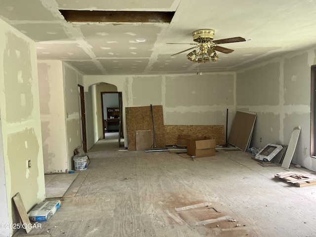 spare room featuring arched walkways and a ceiling fan